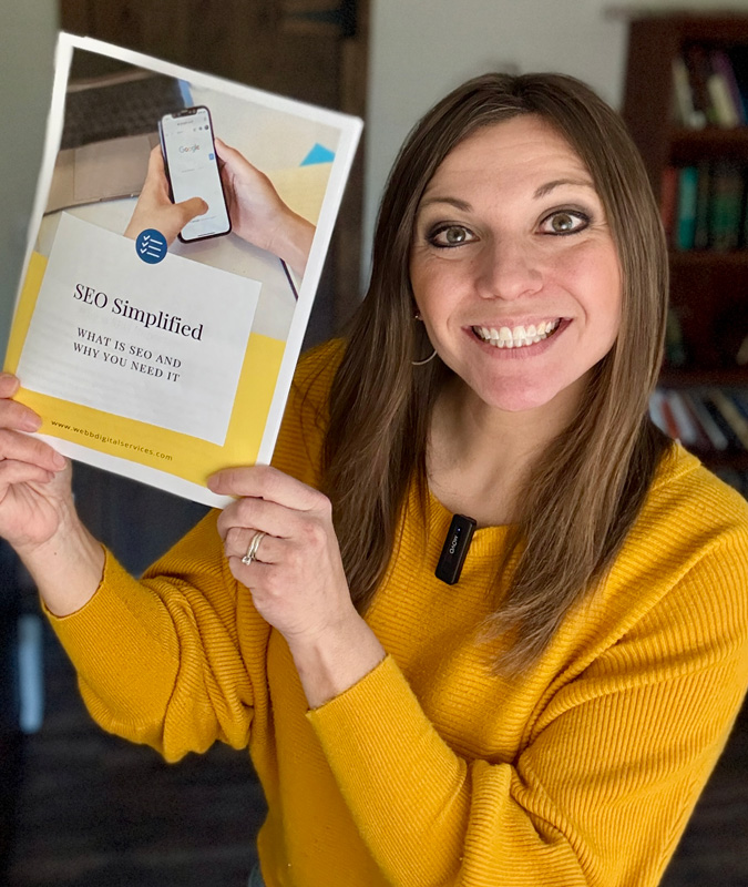 Stephanie holding a printed version of the SEO Simplified Guide